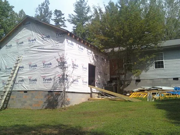 Tyvek wrapped gable on a new room addition beside an existing home in La Grange